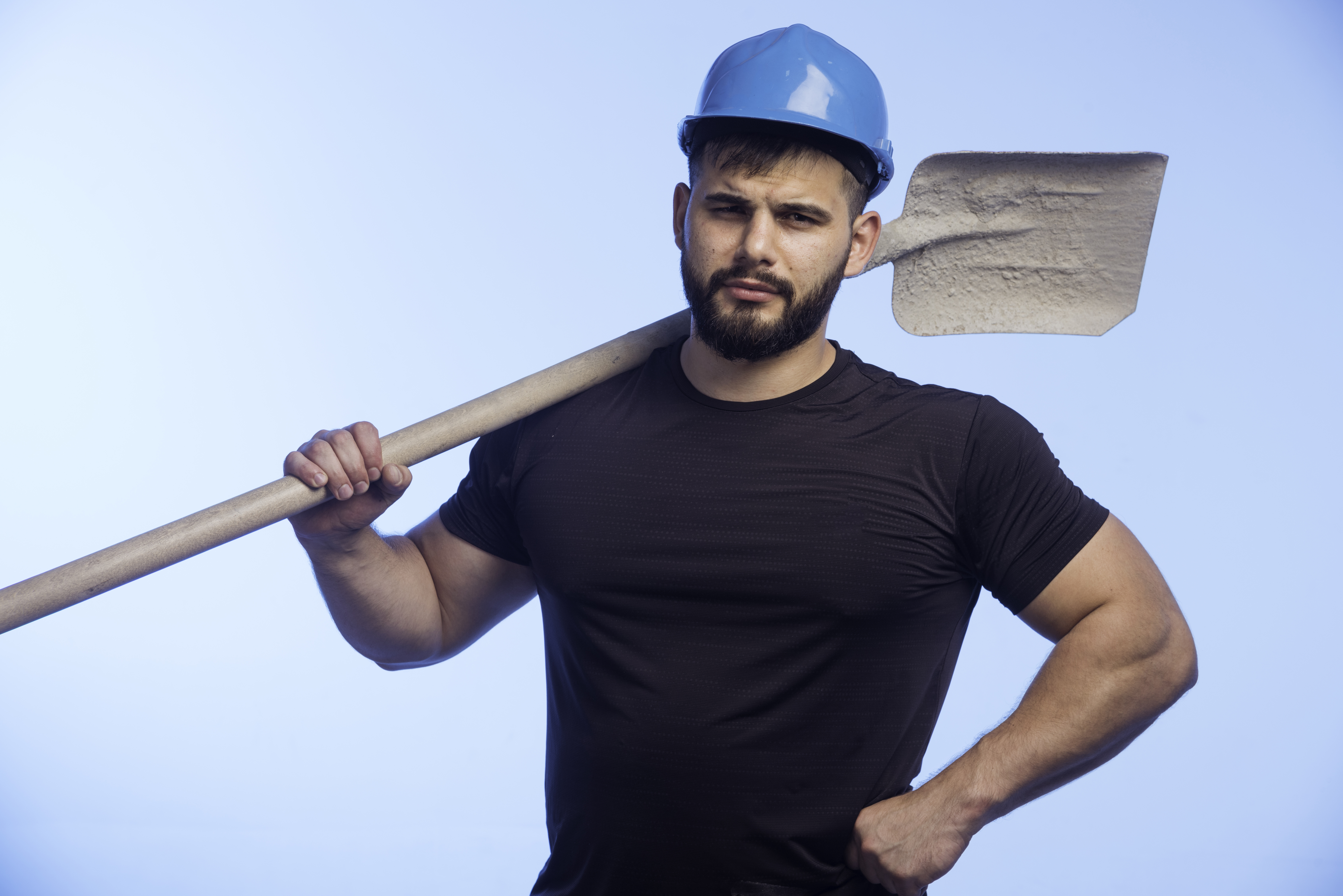 construction-worker-with-blue-helmet-holding-equipment